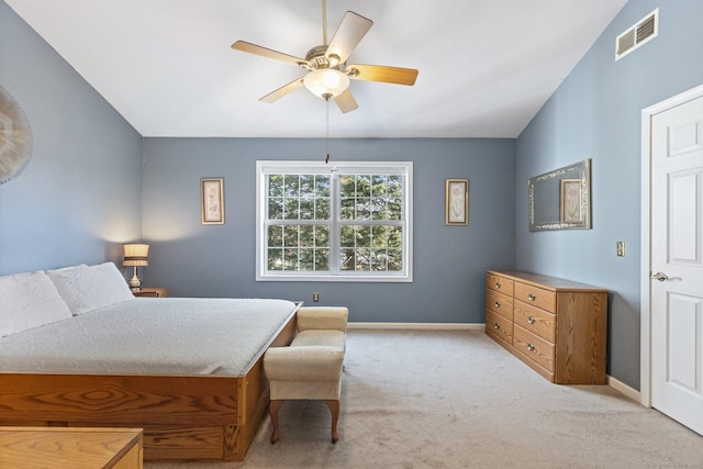 bedroom featuring baseboards, visible vents, lofted ceiling, and light carpet