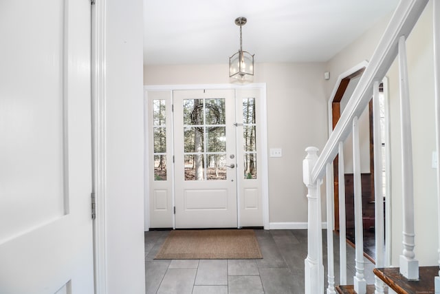 foyer entrance featuring stairs and light tile patterned floors