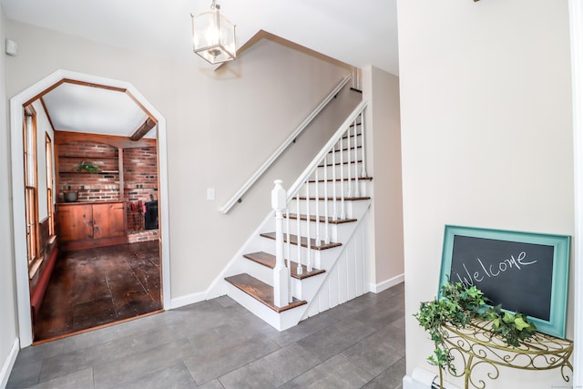 stairs featuring arched walkways and baseboards