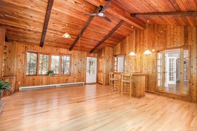 unfurnished living room with lofted ceiling with beams, light wood-type flooring, a baseboard radiator, and wood ceiling