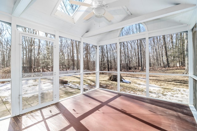 unfurnished sunroom with vaulted ceiling with skylight and a ceiling fan