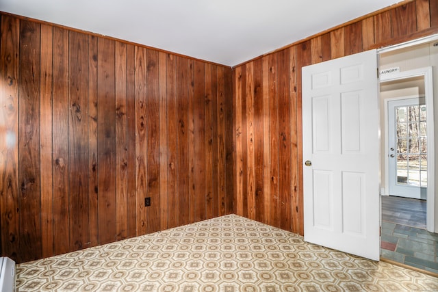 spare room with wood walls