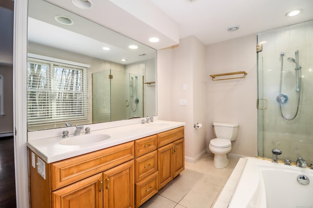 bathroom with tiled shower, a sink, toilet, and tile patterned floors