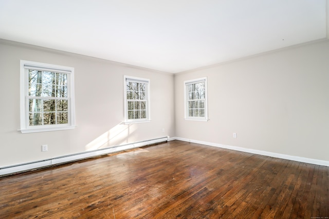 empty room featuring ornamental molding, a wealth of natural light, hardwood / wood-style flooring, and a baseboard radiator