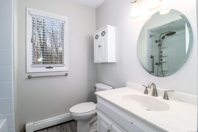 bathroom with a shower, toilet, a baseboard heating unit, vanity, and wood finished floors