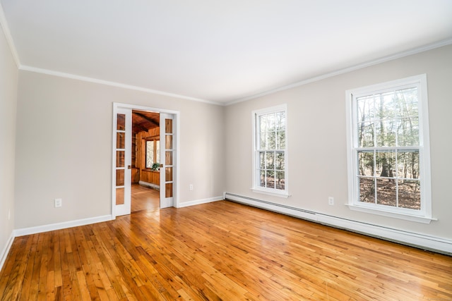 unfurnished room with wood-type flooring, a baseboard heating unit, ornamental molding, and french doors