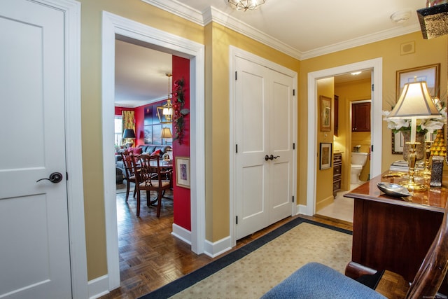 interior space featuring crown molding and baseboards