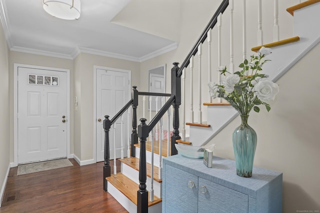 entrance foyer with stairway, baseboards, ornamental molding, and wood finished floors