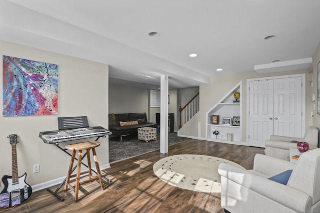 living area with stairs, recessed lighting, wood finished floors, and baseboards