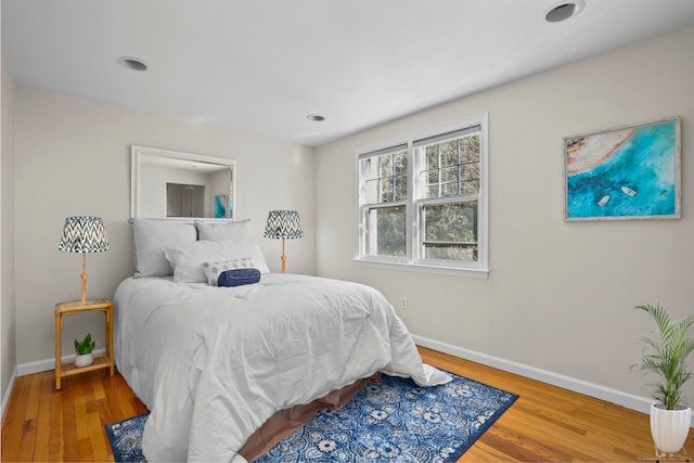 bedroom with baseboards and wood finished floors