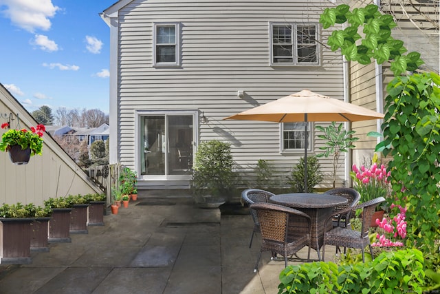 rear view of property with entry steps and a patio area