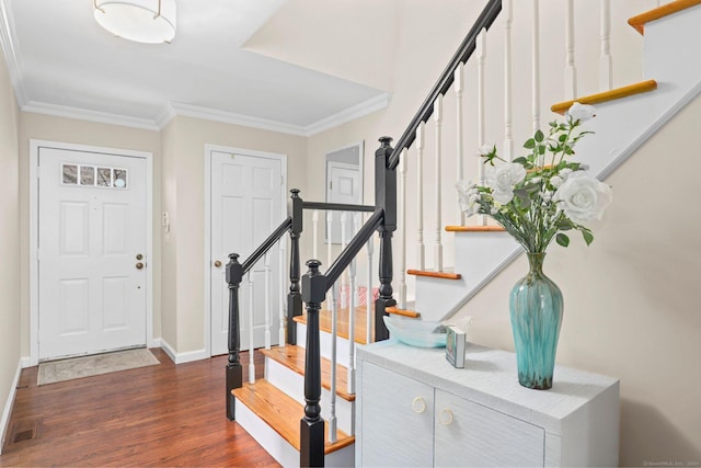 entryway featuring dark wood-style flooring, crown molding, stairway, and baseboards