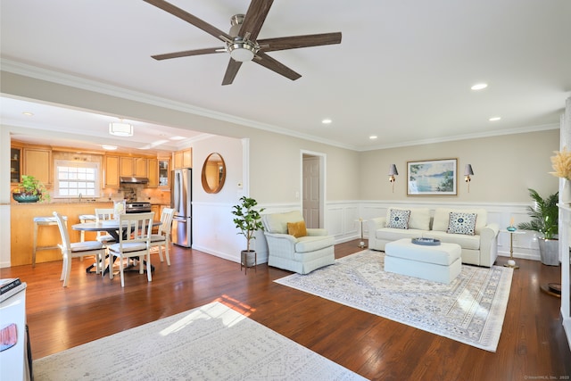 living room with ornamental molding, recessed lighting, dark wood-style flooring, and a wainscoted wall