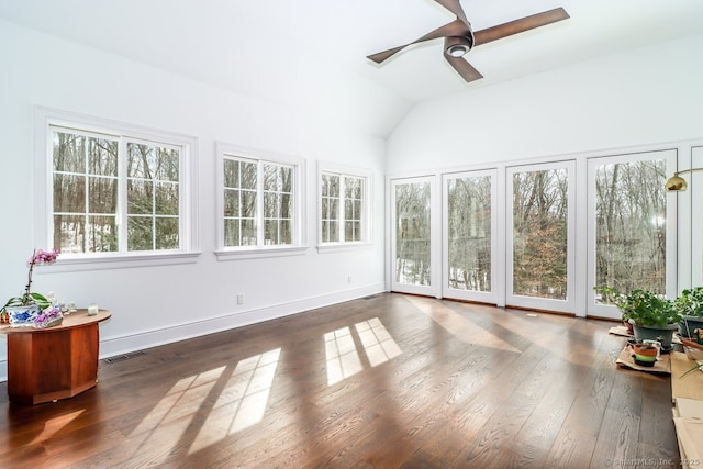 sunroom featuring lofted ceiling, visible vents, and a ceiling fan