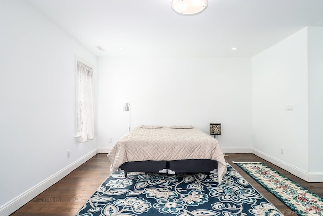 bedroom featuring wood finished floors and baseboards