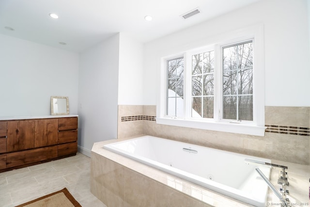 full bath with a jetted tub, tile patterned floors, visible vents, and recessed lighting