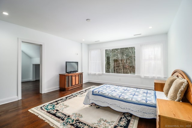 bedroom with multiple windows, dark wood finished floors, visible vents, and baseboards