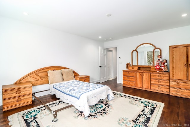 bedroom with dark wood-style floors and recessed lighting