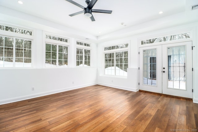 unfurnished sunroom featuring french doors, visible vents, and ceiling fan