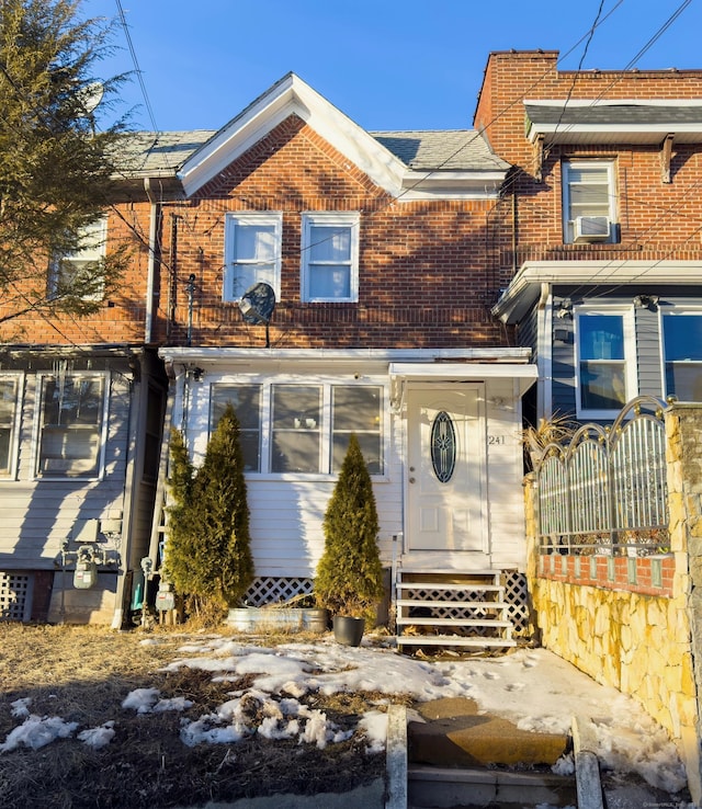 view of front of home with entry steps and brick siding