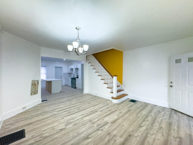 interior space with ornamental molding, stairway, visible vents, and light wood-style floors