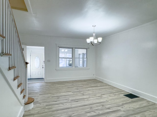 entrance foyer with visible vents, baseboards, stairway, light wood-type flooring, and an inviting chandelier