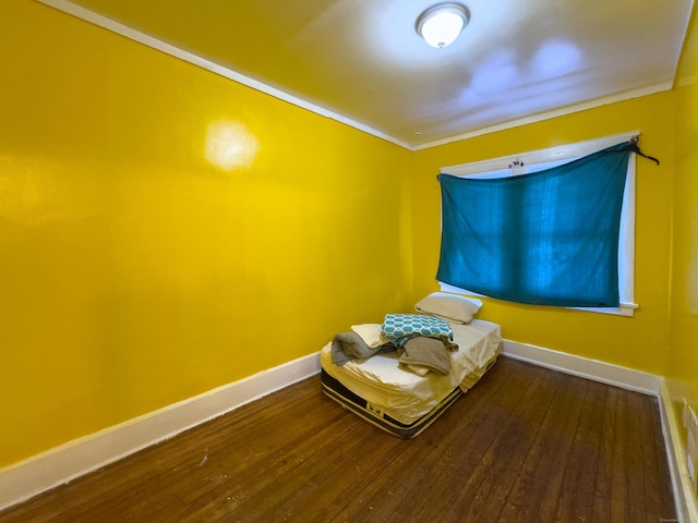 unfurnished bedroom featuring hardwood / wood-style flooring and baseboards