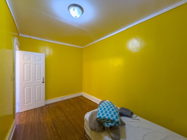 interior space featuring baseboards and dark wood-type flooring