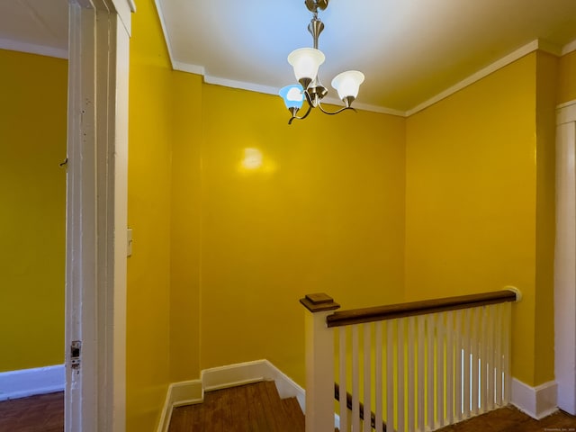 staircase featuring a notable chandelier, baseboards, and crown molding