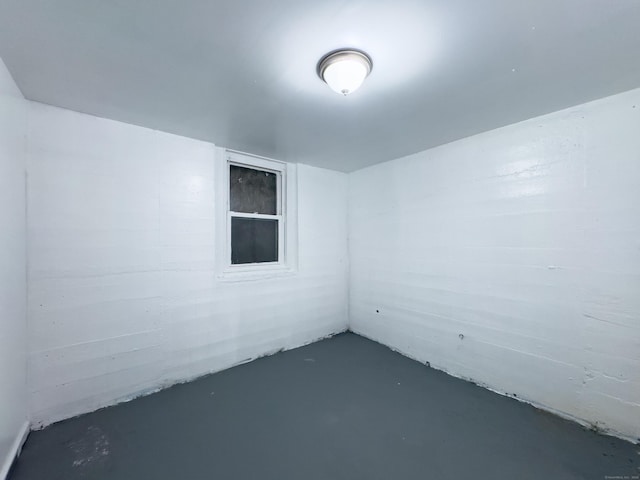 unfurnished room with finished concrete flooring