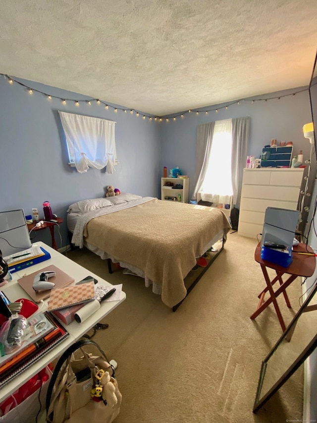 bedroom with carpet floors and a textured ceiling