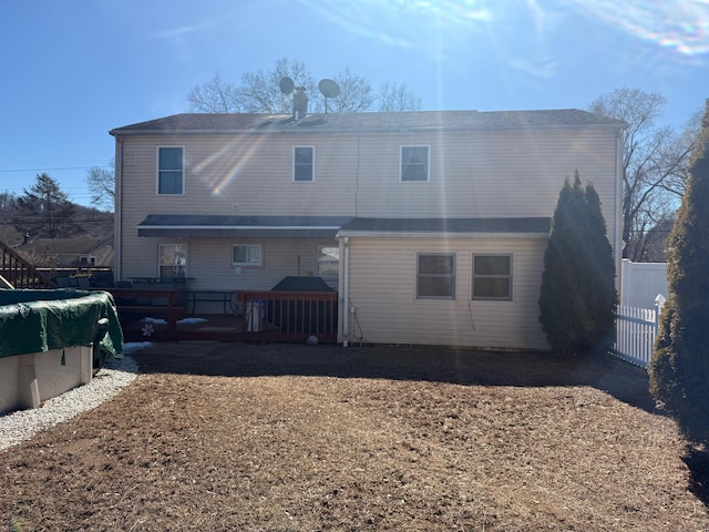 back of house featuring fence