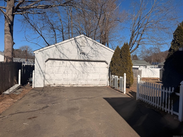 detached garage featuring fence