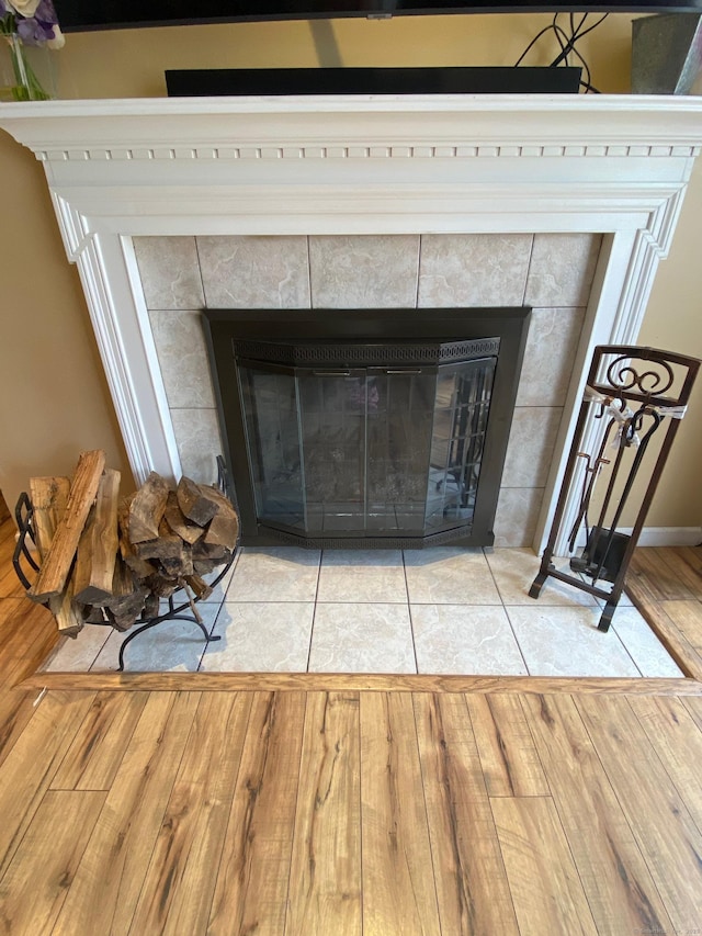 room details featuring a fireplace and wood finished floors