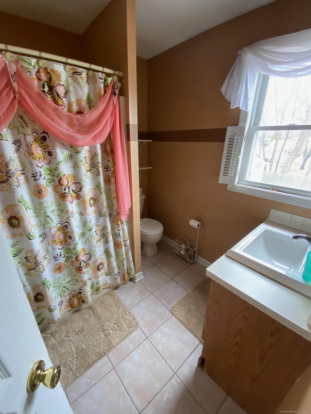 full bathroom with toilet, tile patterned flooring, baseboards, and vanity