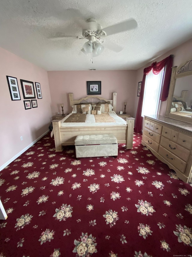 carpeted bedroom featuring a ceiling fan, a textured ceiling, and baseboards