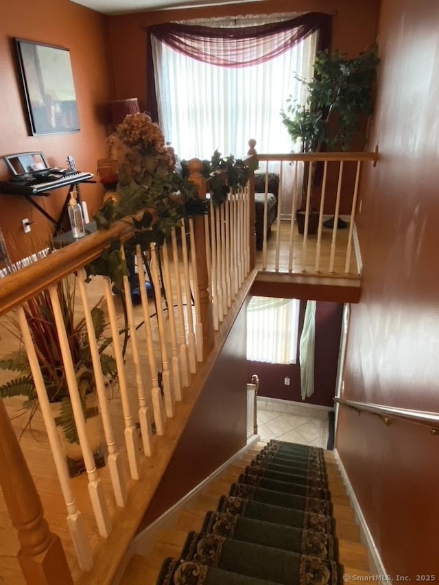 staircase with tile patterned flooring and baseboards