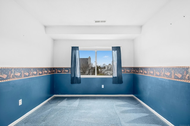 empty room featuring carpet floors, baseboards, and visible vents