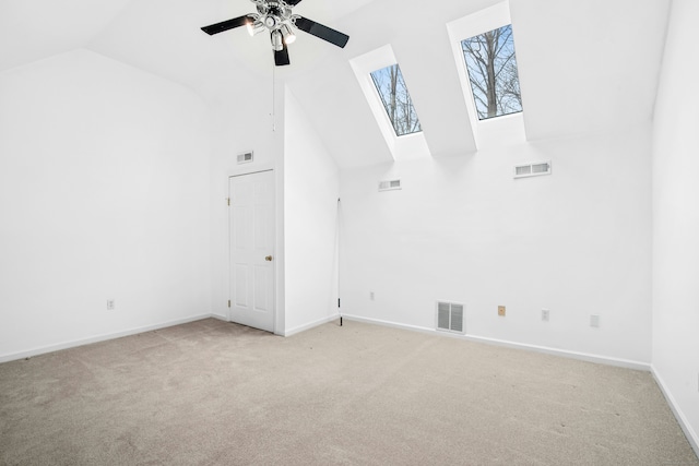 interior space with high vaulted ceiling, visible vents, and light carpet