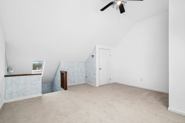 bonus room with lofted ceiling, ceiling fan, carpet, and baseboards