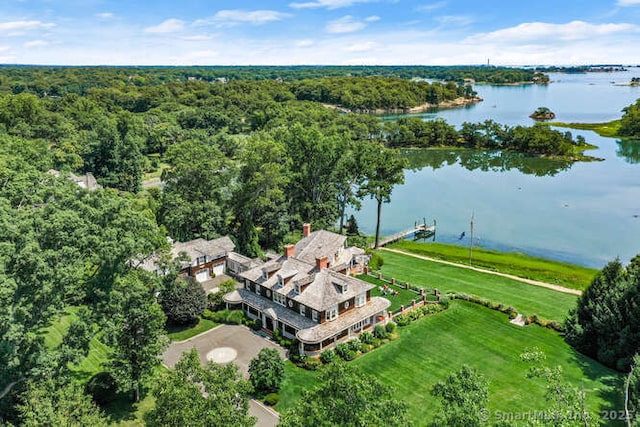 birds eye view of property with a water view and a wooded view