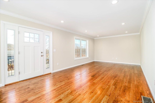 foyer entrance with visible vents, baseboards, light wood-style flooring, ornamental molding, and recessed lighting