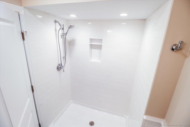 bathroom with recessed lighting and a shower stall