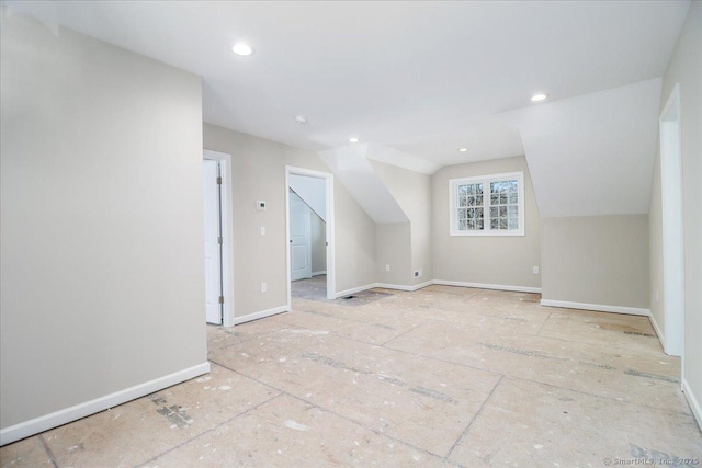 bonus room with baseboards, vaulted ceiling, and recessed lighting