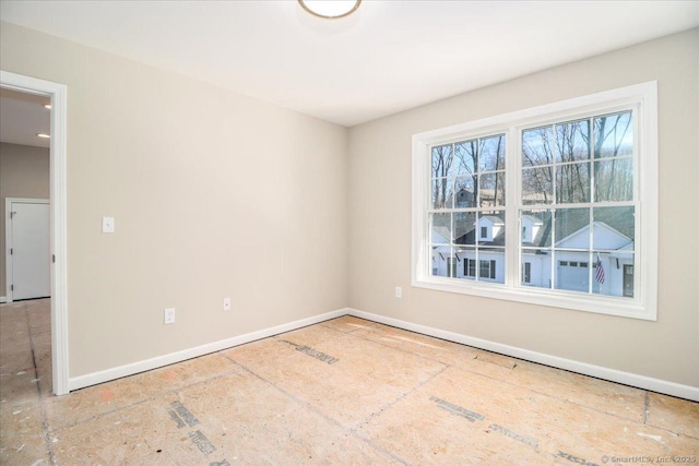 spare room featuring baseboards