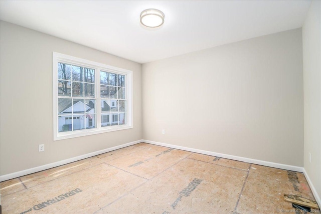 empty room featuring baseboards