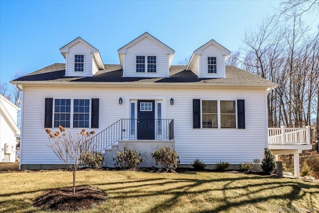 new england style home with central AC and a front lawn