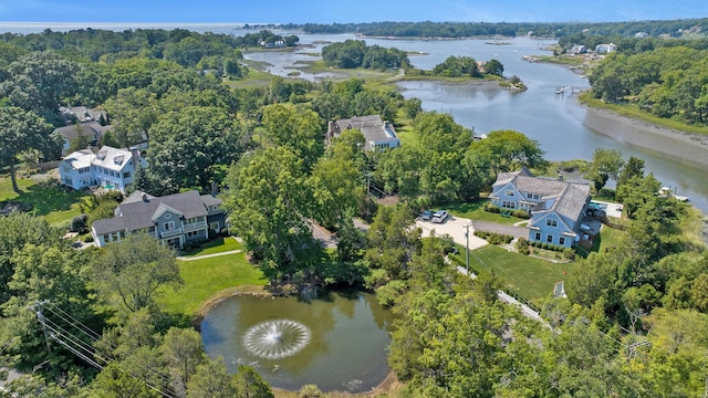 drone / aerial view with a water view and a wooded view