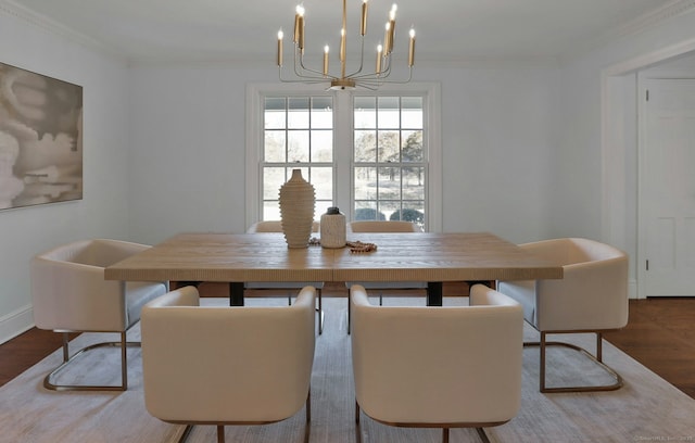 dining area with baseboards, crown molding, and wood finished floors