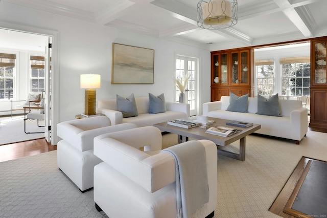 living room featuring ornamental molding, coffered ceiling, and beamed ceiling